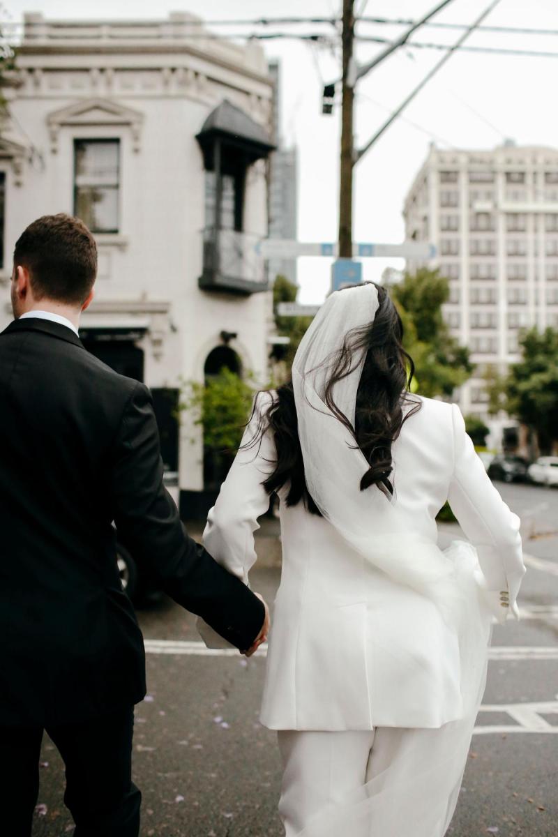 Real bride Megan Kelly elopes wearing the Charlie Danielle bridal suit by Karen Willis Holmes, small wedding ceremony at court.