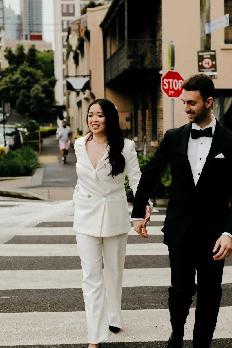 Real bride Nicole with her new husband wearing the Charlie Danielle, a tailored bridal suit and simple veil by Karen Willis Holmes.