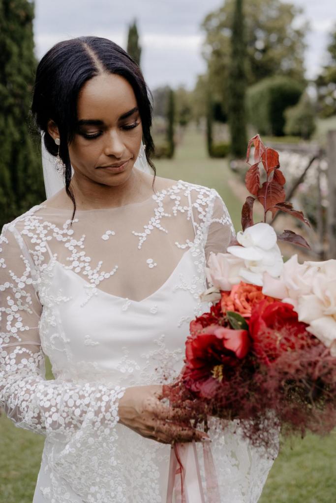 Real bride Saliya wearing the Pascale gown; a long sleeve nontraditional lace wedding dress by Karen Willis Holmes.