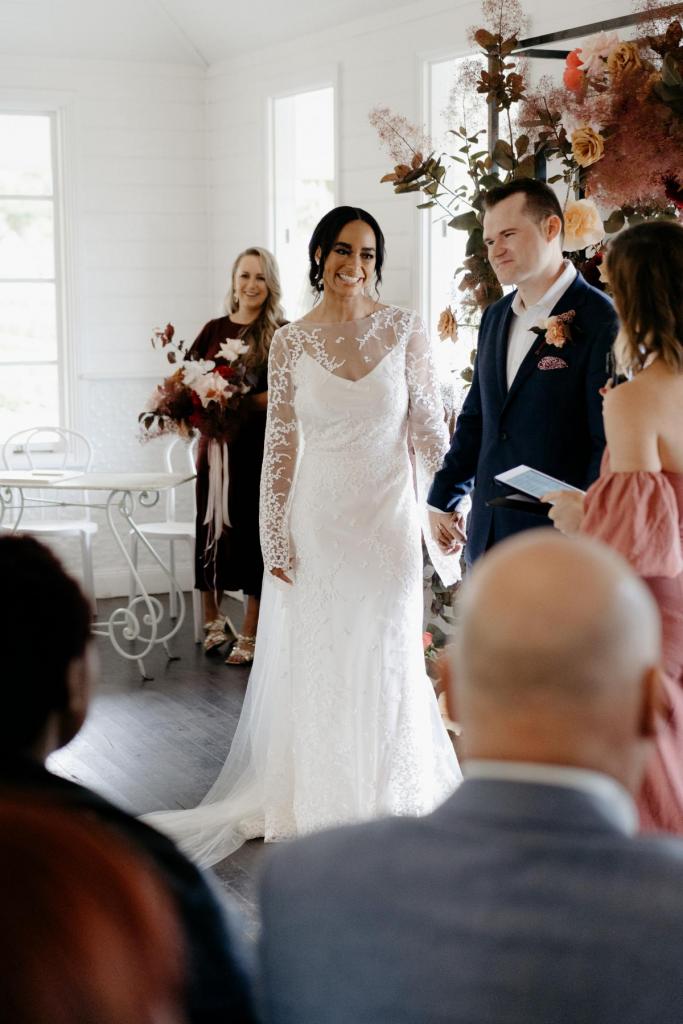Real bride Saliya at her wedding ceremony, wearing the Pascale gown; a boho lace wedding dress from Karen Willis Holmes.