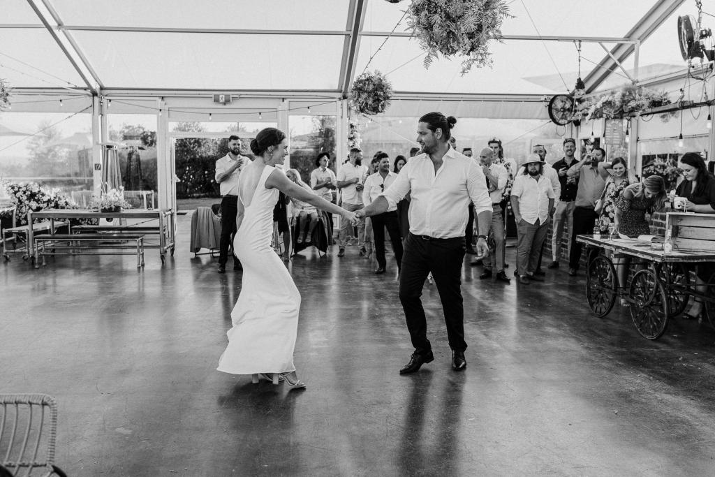 New bride, Kate dances the day away with her husband, Mik, on the dance floor. She wears the modern Arabella gown by KWH.