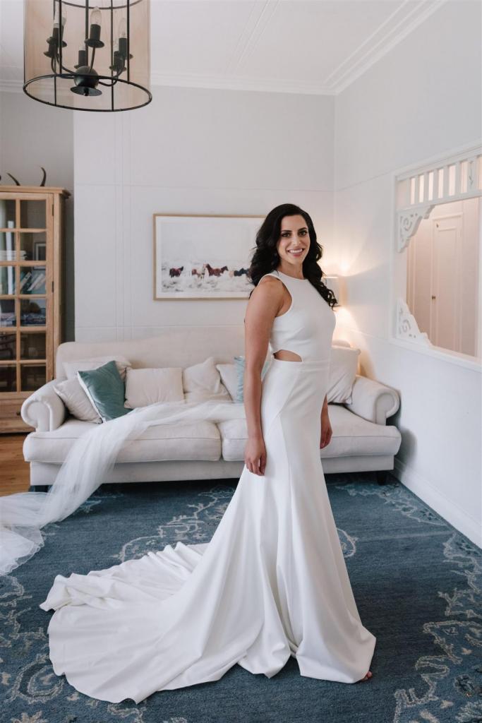 Real Bride Marianne getting ready for her Sydney wedding wearing the Bridget gown & Lea Skirt; a simple halter neckline wedding dress with pearl skirt overlay by Karen Willis Holmes.