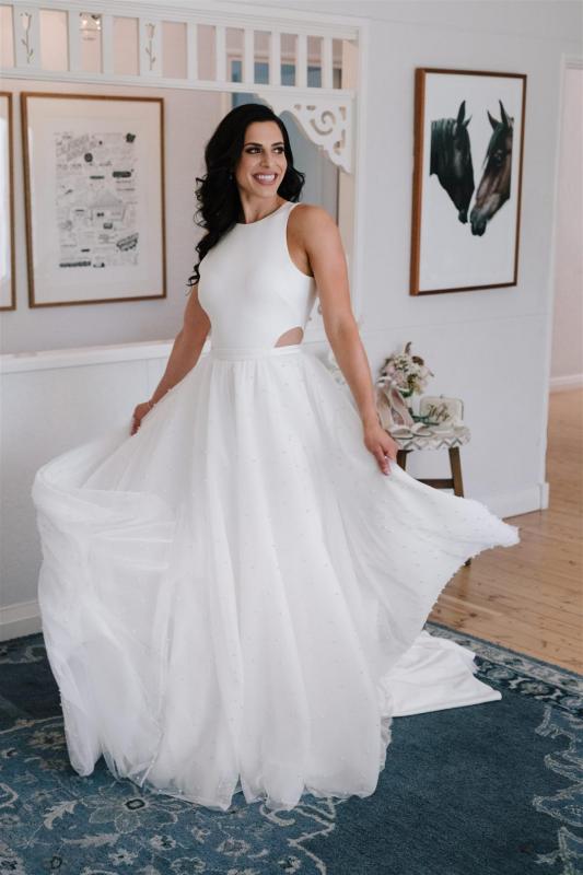 Real Bride Marianne getting ready for her Sydney wedding wearing the Bridget gown & Lea Skirt; a simple halter neckline wedding dress with pearl skirt overlay by Karen Willis Holmes.