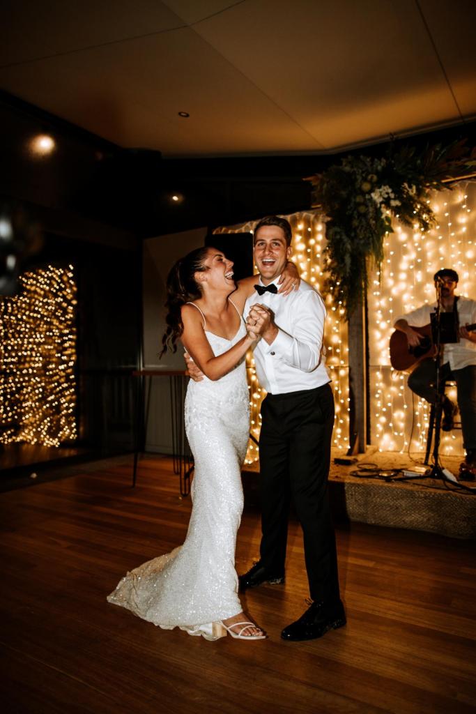 Real bride Ruby and Taylor dancing the night away while glowing in her beaded v-neck dress, Darcy by Karen Willis Holmes.
