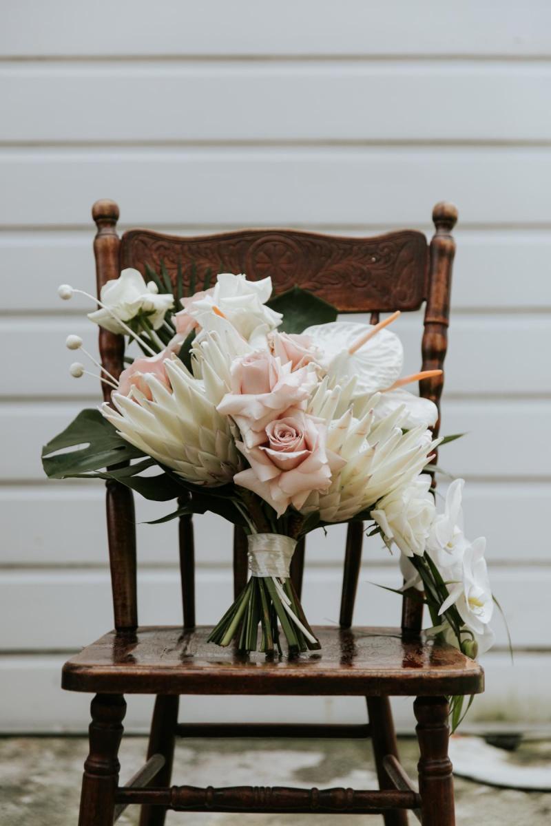 Native bouquet by Melissa Jane sits on antique chair at Jarna and Aden's destination wedding in New Zealand.