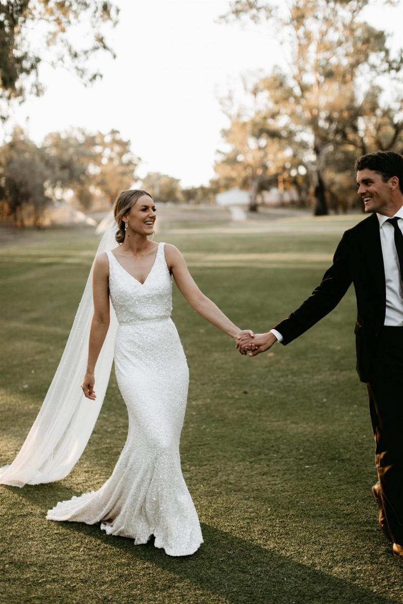 Real bride Bre with her husband Ted at their Melbourne wedding, wearing the Lola gown; a beaded fit n flare wedding dress by Karen Willis Holmes.