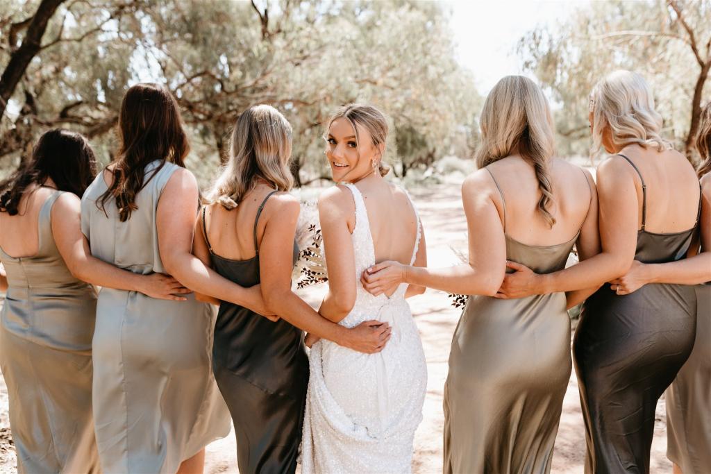 Real bride Bre poses with her bridesmaids in olvie, wearing the Lola gown; a beaded fit n flare wedding dress by Karen Willis Holmes.