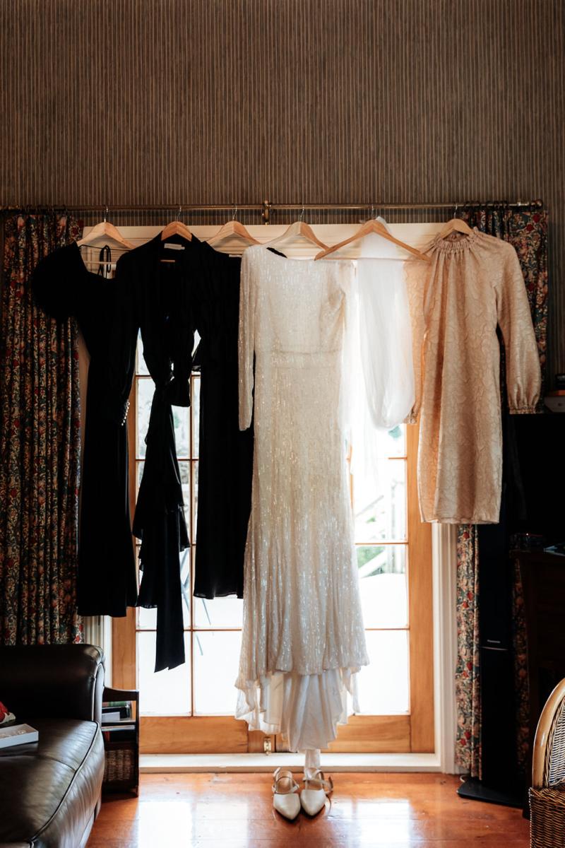 KWH Real bride, Hannah's Margareta gown hangs in the door way along with her bridesmaids dressing gowns.