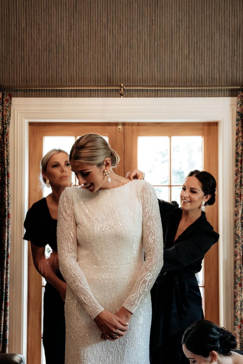 KWH Real bride, Hannah's Margareta gown hangs in the door way along with her bridesmaids dressing gowns.