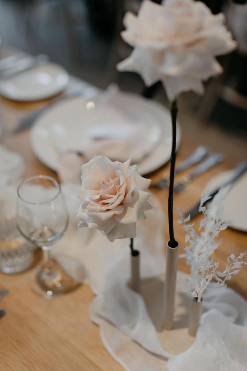 Real bride Nicole's white wedding cake with blush and white florals decorating it made by Art of Baking.