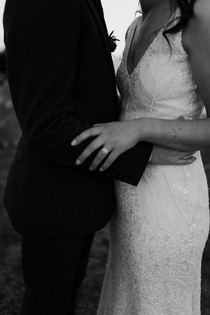 KWH real bride Amber and Stewart up close shot of the pair in a black and white photo. She dons the beaded Olympia wedding dress with matching belt.