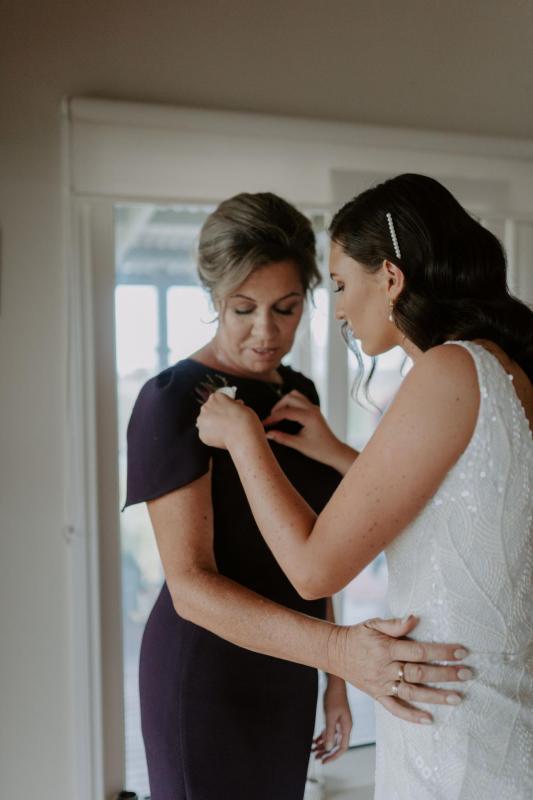 Real bride Amber helping her mom get ready. Amber wears the Olympia beaded gown from KWH.
