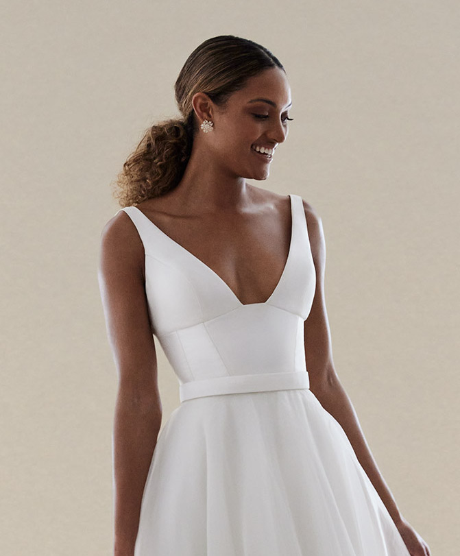 The Taryn bodice by Karen Willis Holmes, a simple, U-neckline wedding dress bodice with straps paired with the organza Joni skirt.