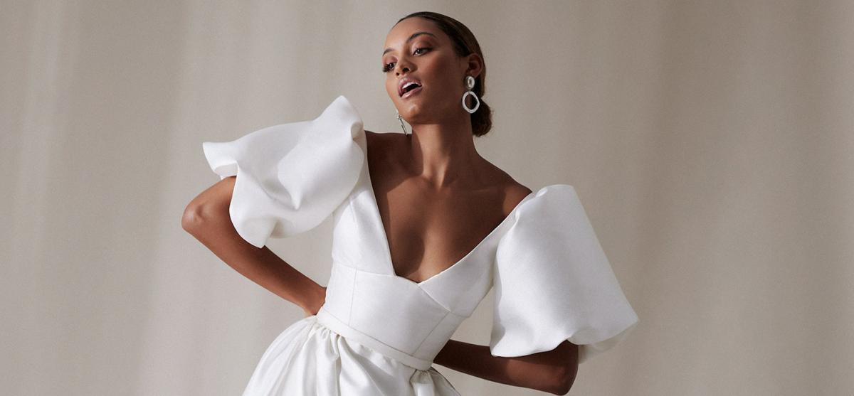 The Taryn bodice by Karen Willis Holmes, a simple, U-neckline wedding dress bodice with straps paired with the oversized Bubble sleeves and classic Camille skirt.