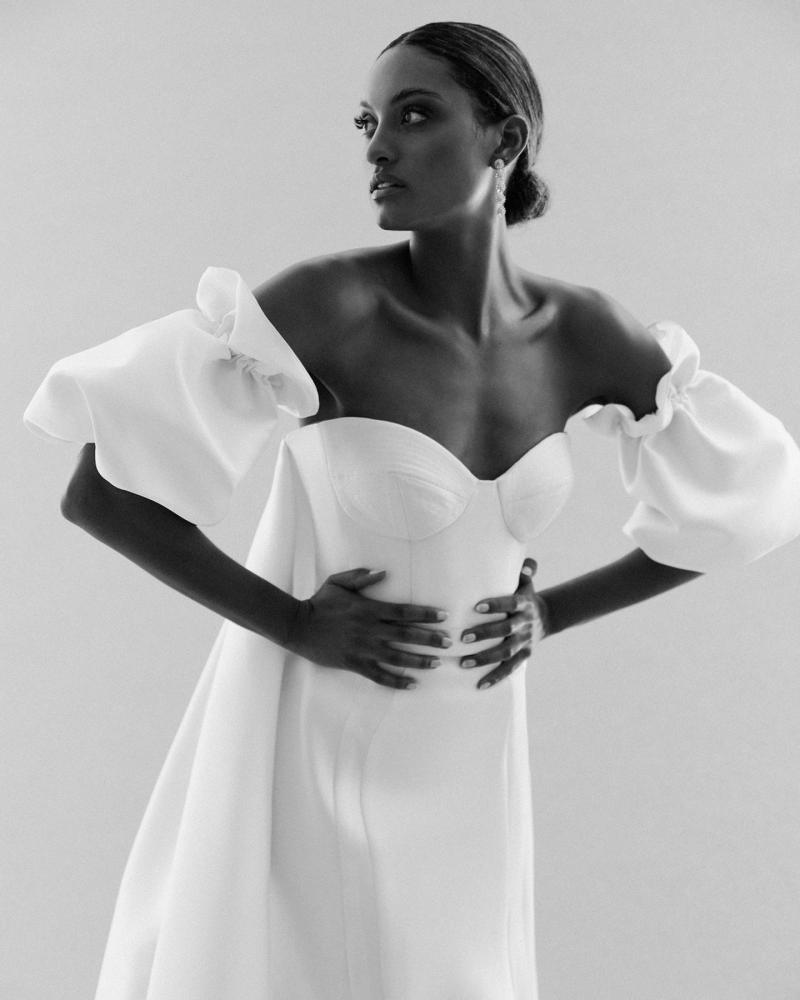 The Blake bodice by Karen Willis Holmes, a simple bustier wedding dress bodice with Puff sleeves and Lindy train. Up close B&W shot.