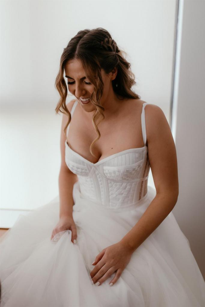 Real bride Gaby getting ready for her wedding, wearing the Scarlett gown; a strapless corset wedding dress by Karen Willis Holmes.