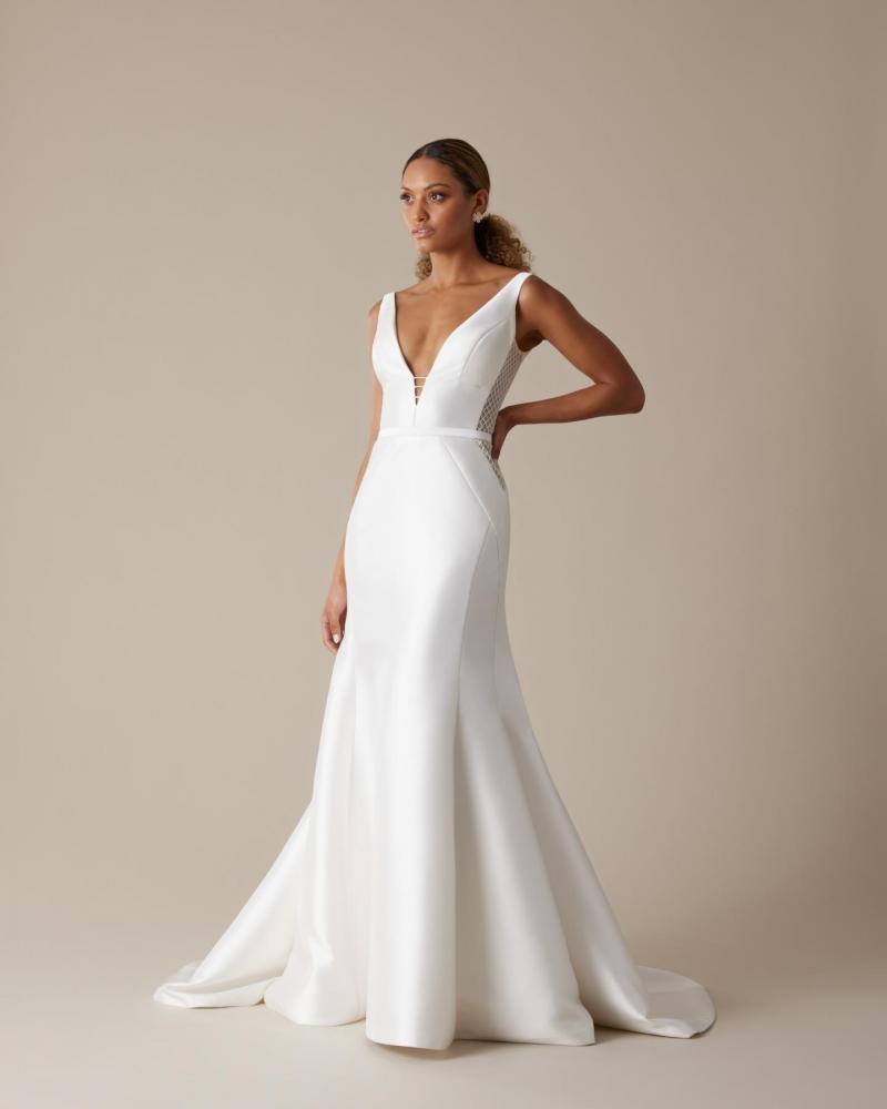 The Shelly Samantha by Karen Willis Holmes, a simple plunging neckline wedding dress with straps and fit and flare skirt.