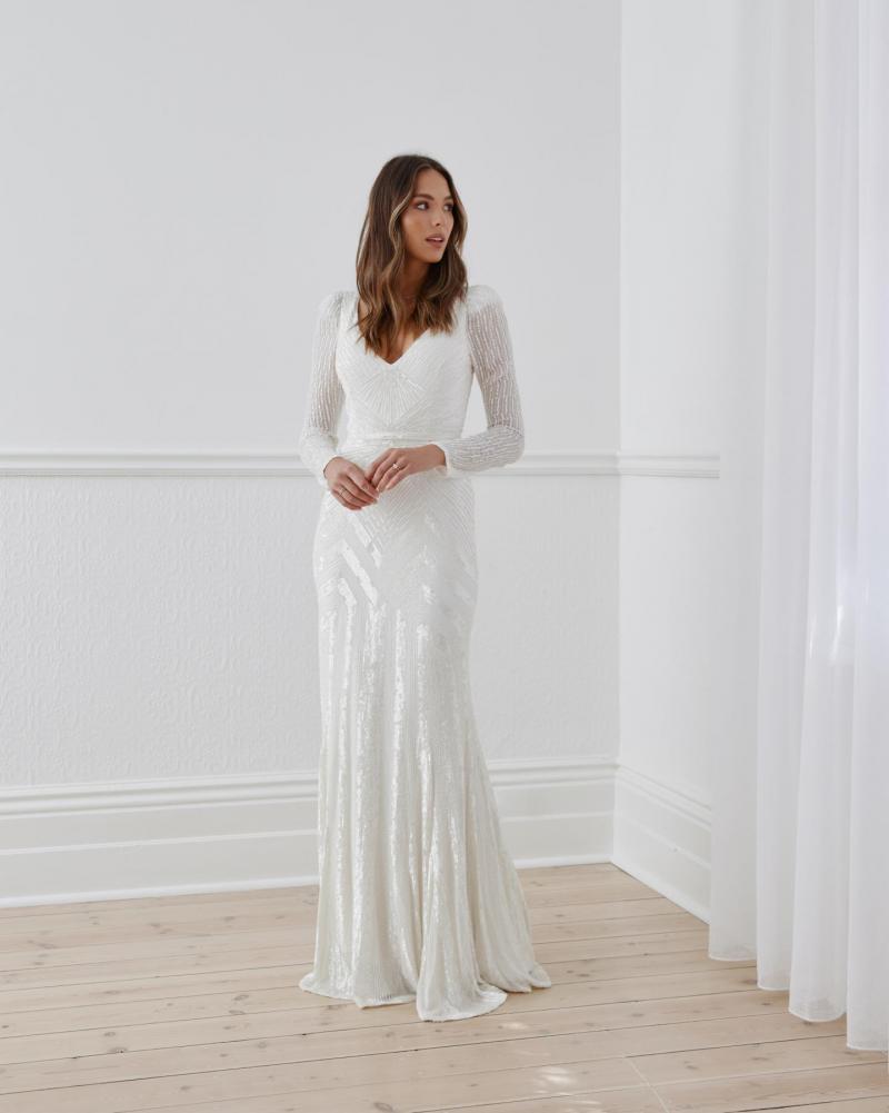 The Perry gown by Karen Willis Holmes, a V-Neck long sleeve beaded wedding dress with a fit and flare shape.