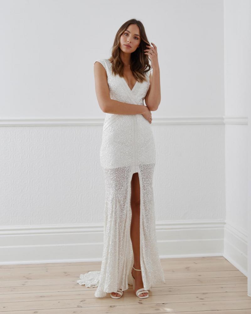 The Georgie gown by Karen Willis Holmes, a deep V-Neck beaded wedding dress with an open back and a split skirt.