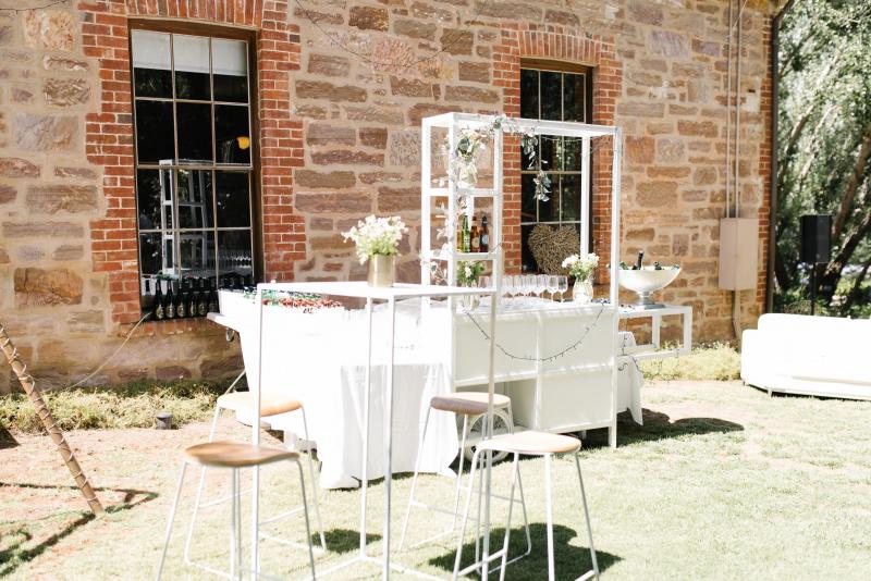 White roses with green leaves on a white lattice arbour at KWH real bride Bec's wedding