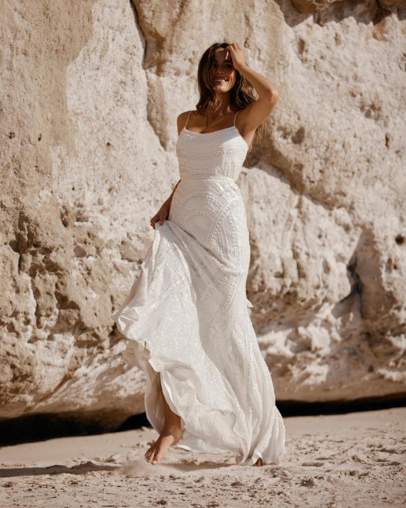 The Isabelle gown by Karen Willis Holmes, a unique spaghetti strap beaded wedding dress with a fit and flare shape.