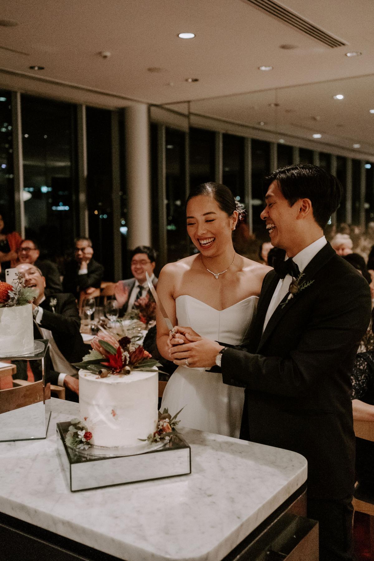 KWH real bride Sarah and Brian cut the cake at their recpetion. She wears the sweetheart Kitty Joni Bespoke gown.