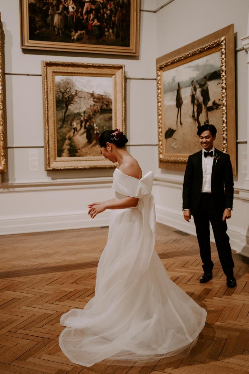 KWH real bride Sarah dancing in the art gallery with new husband Brian. She wears the simple yet elegant Kitty Joni gown.