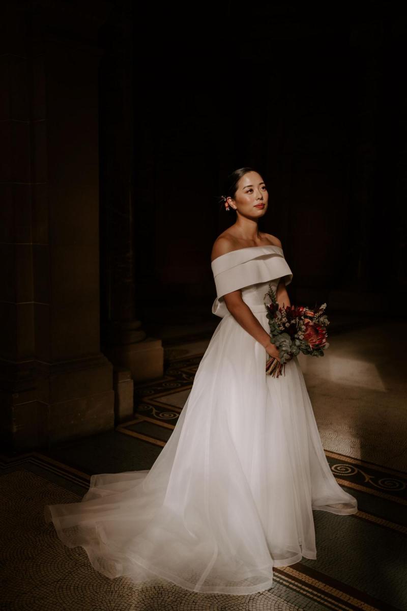 KWH real bride Sarah stands in her Bespoke Kitty Joni gown with sweet heart neckline and tulle skirt.