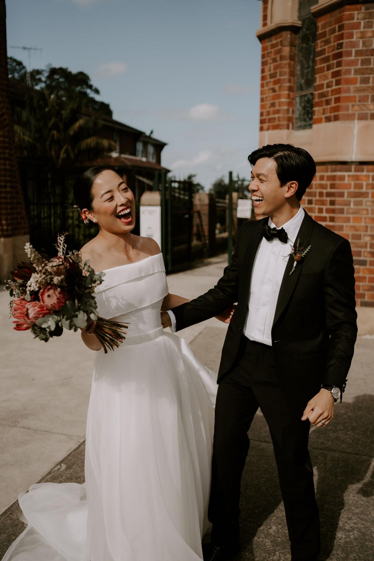 KWH real bride Sarah stands in her Bespoke Kitty Joni gown with sweet heart neckline and tulle skirt.