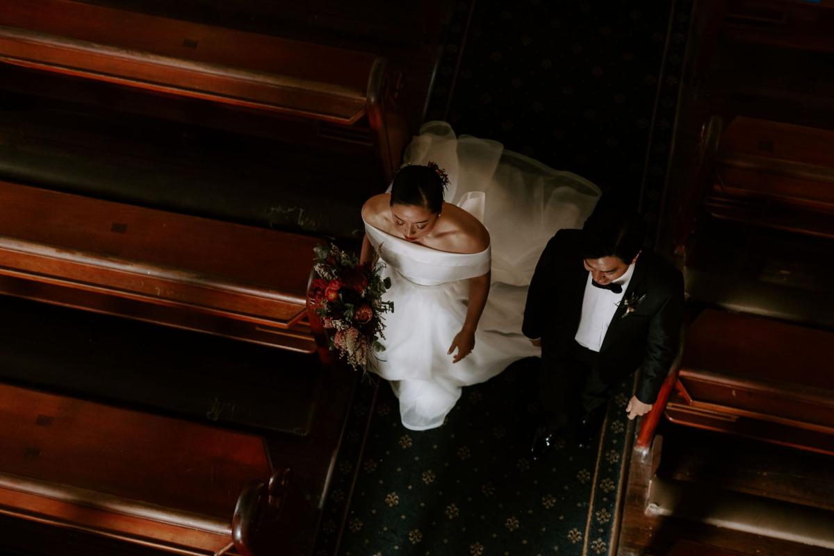 KWH bride Sarah and brian leave the church down the aisle. She wears the timeless Kitty Joni bespoke gown by KWH.