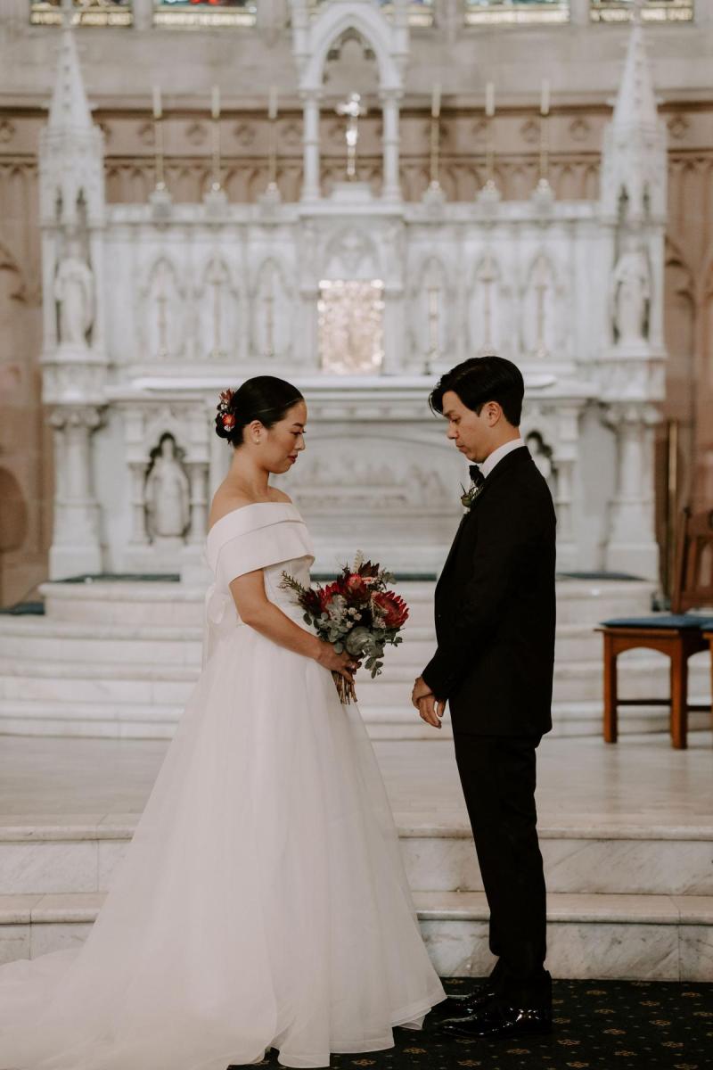 KWH real bride Sarah and Brian walking up to the alter at Our Lady of the Sacred Heart Catholic Church in Randwick.