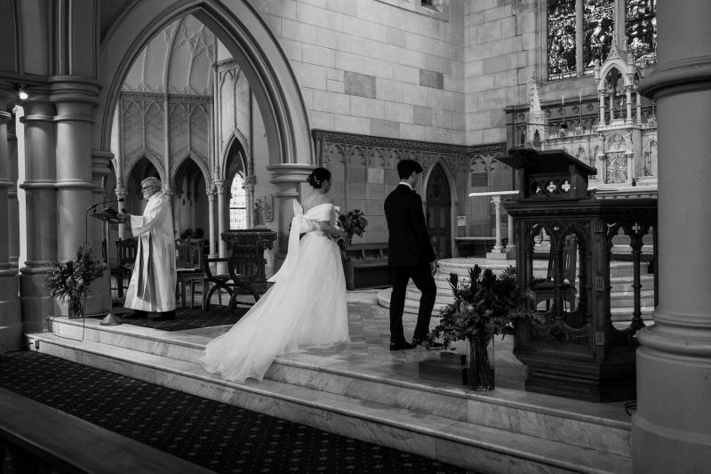 KWH real bride Sarah and Brian walking up to the alter at Our Lady of the Sacred Heart Catholic Church in Randwick.