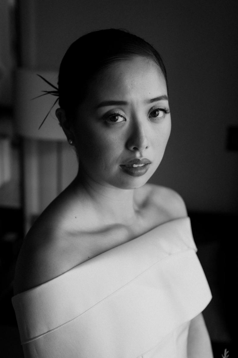 B&W photo of KWH real bride Sarah before her ceremony. She wears the ivory Kitty Joni gown with twill custom sash.