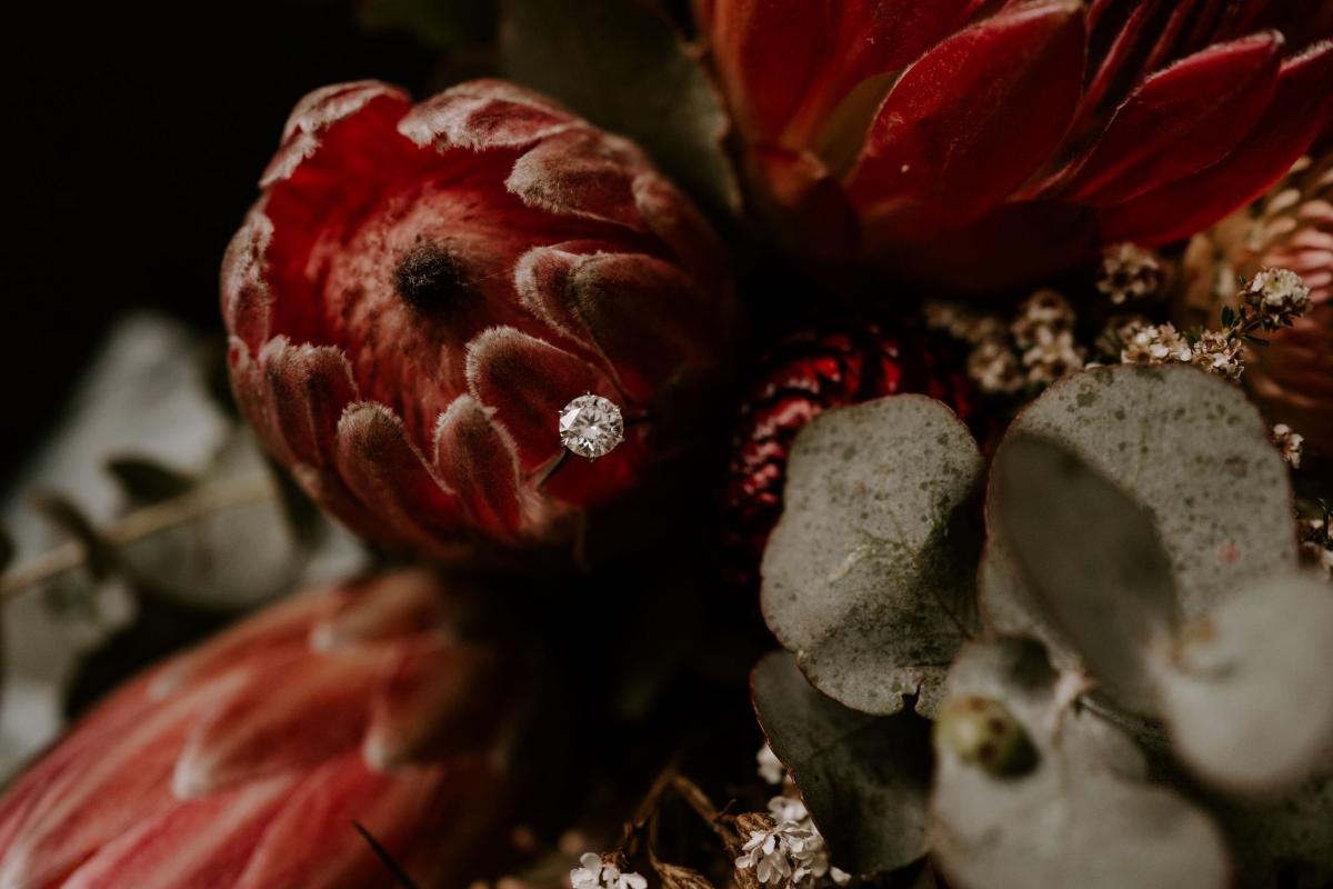 KWH real bride Sarah's bridal bouquet from Petal and Fern with her engagement ring on a flower.