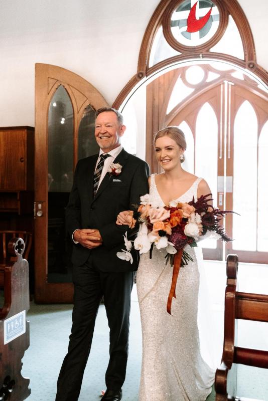 KWH real bride Katie enters the church with her dad in her fit and flare Lola gown.