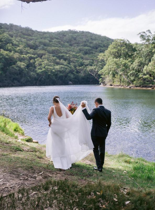 KWH bride Annalese walks by the lake with her new hubby. She wears the classy Aisha gown with aline skirt.
