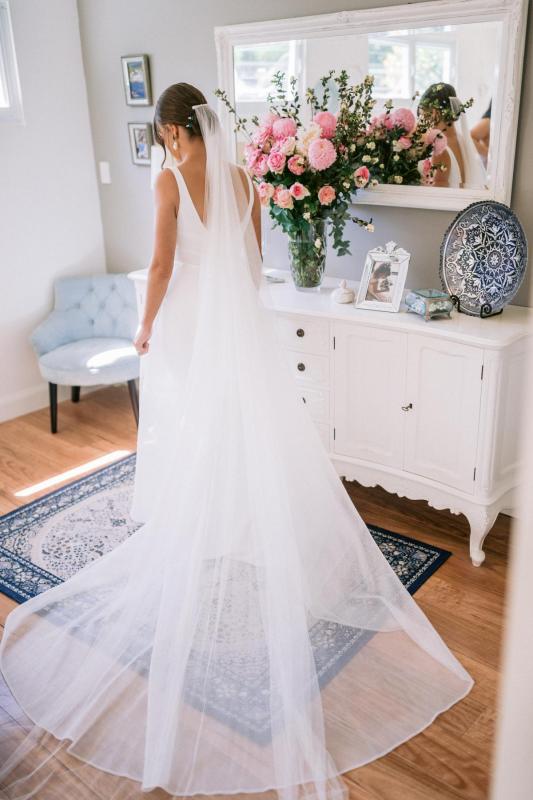 KWH real bride Annalese stands in her ivory mesh Aisha gown as she gets ready.