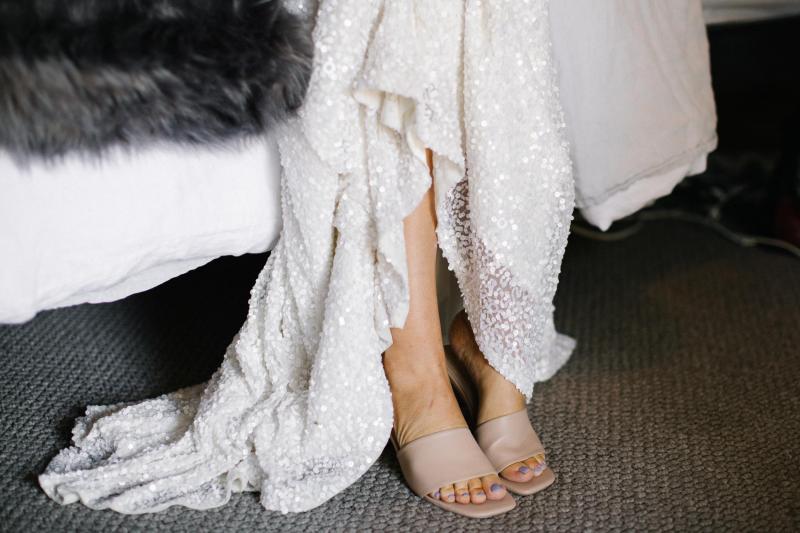 KWH real bride Bec's Luxe Olympia gown hanging in the window. The gown features organic inspired beads.