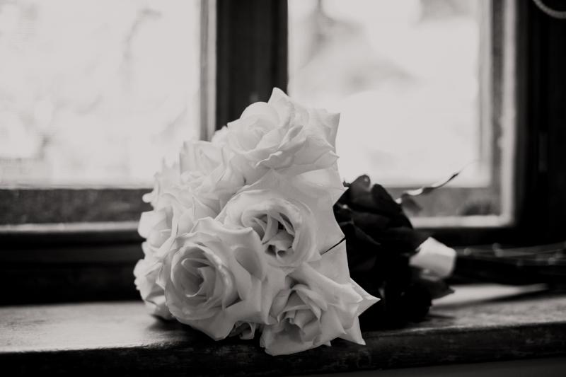 KWH real bride Bec's Luxe Olympia gown hanging in the window. The gown features organic inspired beads.