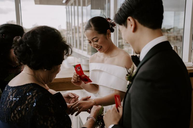 KWH real bride Sarah and Brian bowing to their mothers for their tea ceremony. She wears the traditonal Kitty Joni gown.