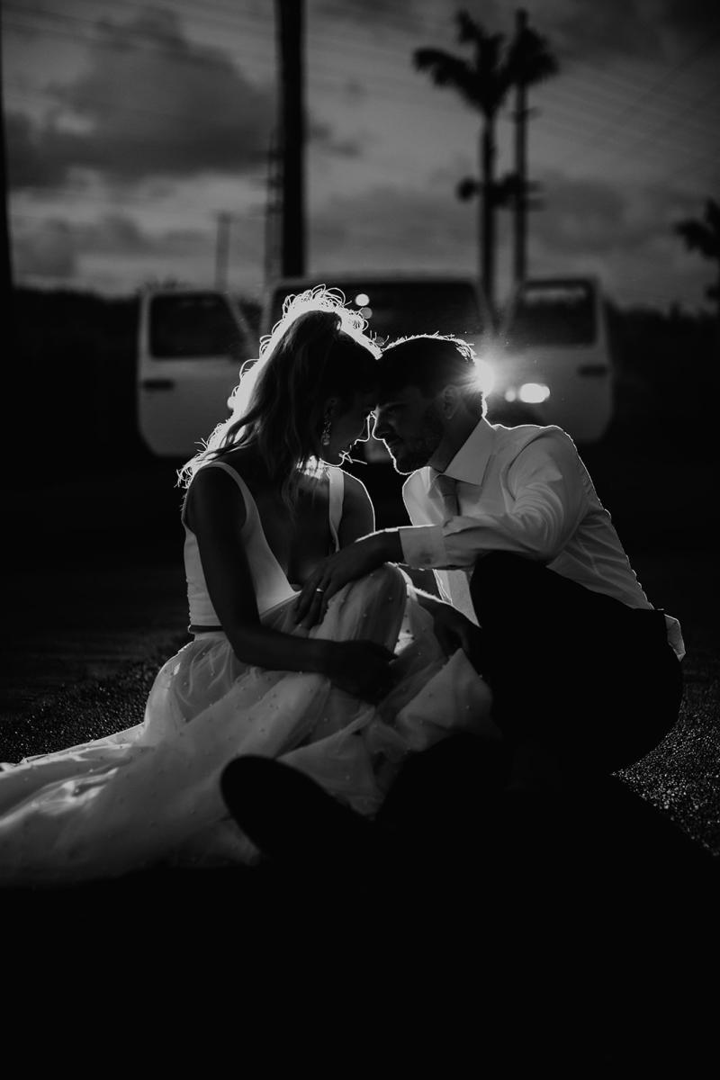 KWH real bride Jana dances in her Erin and Lea two piece wedding dress set in front of the headlights of a jeep after her modern elopement.