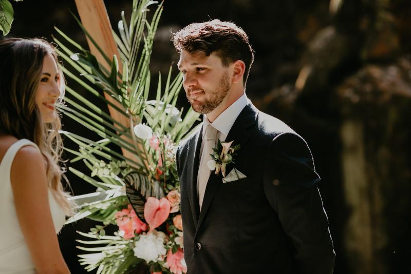 KWH real bride Jana and Garret walk out of their quaint Hawaiian bungalow to their ceremony. She wears the contemporary Erin and Lea wedding dress set with seperate pieces.