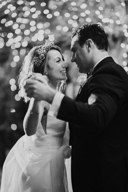 KWH real bride Talia dancing with her new husband. She wears the bespoke Aisha wedding dress with u-shaped neckline and mesh material.
