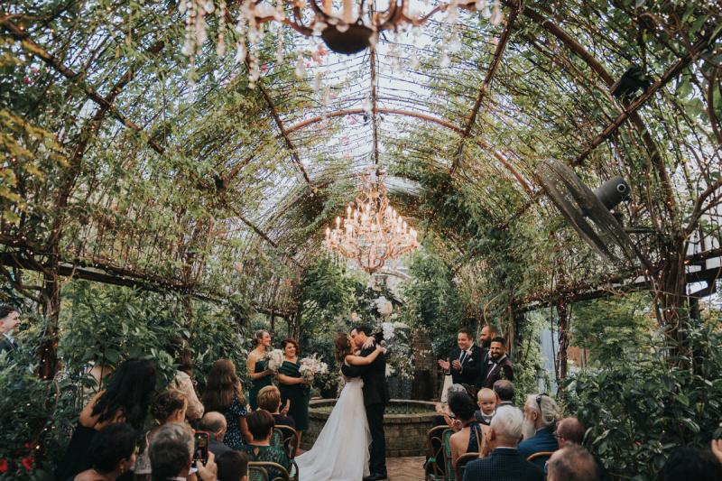 KWH real bride Talia's first kiss at her enchanting ceremony. She wears the Bespoke Aisha wedding dress with voluminous aline skirt and modern neckline.