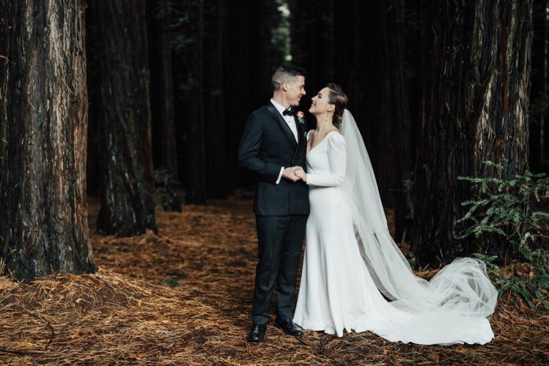 KWH real bride Jaci wears the refined Aubrey wedding dress with long sleeves.