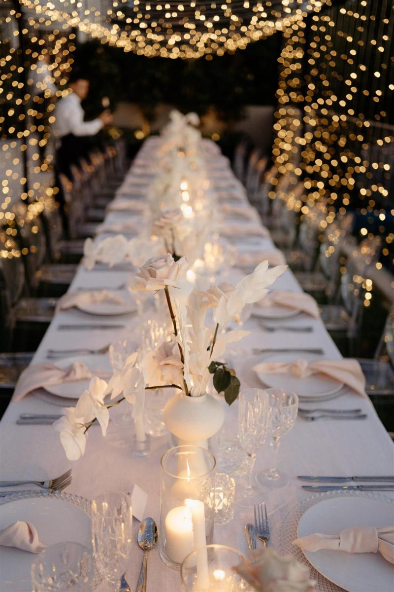 KWH real bride Demi's reception with fairy lights and soft white linenes.