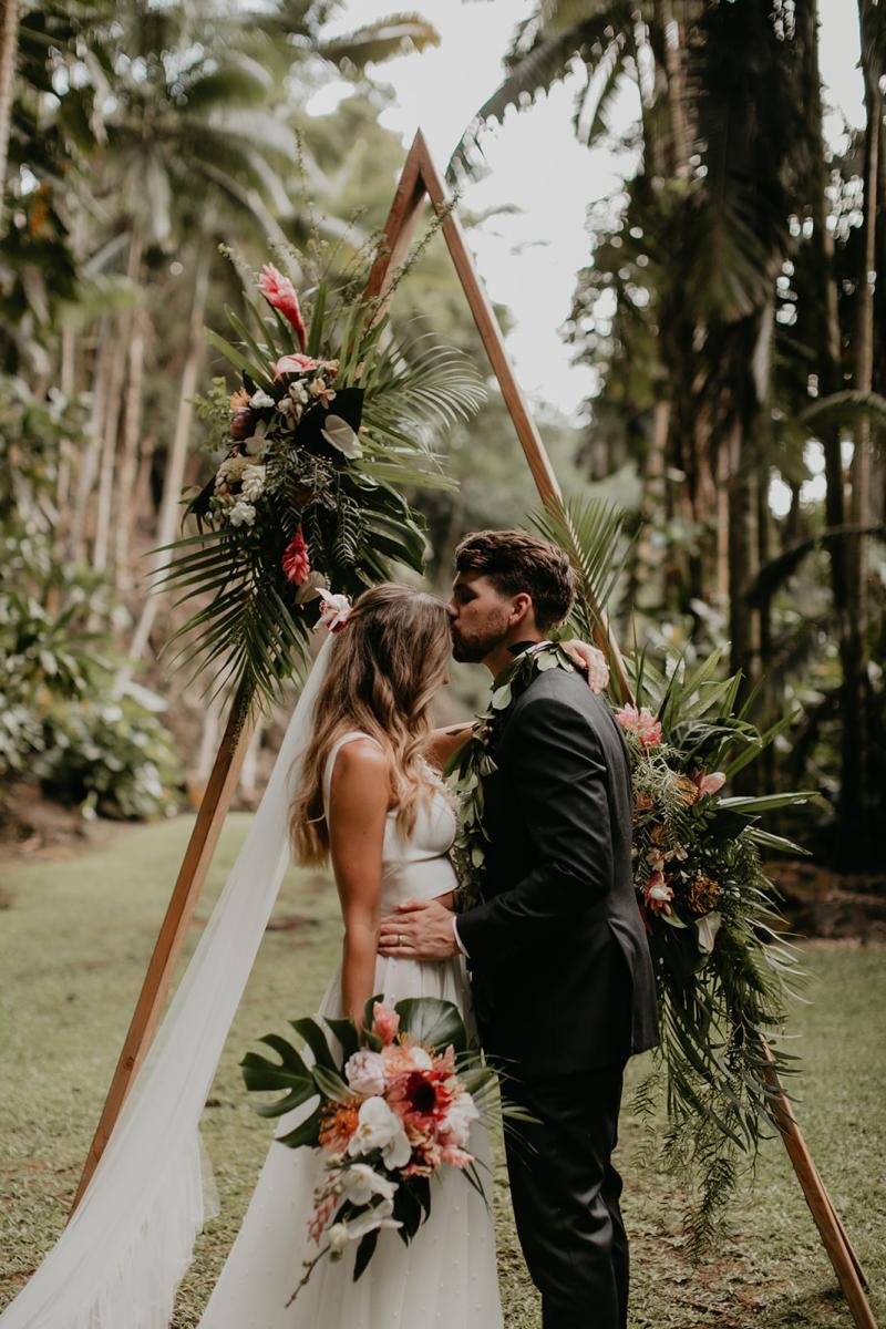 KWH real bride Jana gets a forehead kiss from her new husband Garret. She wears the modern Erin and Lea two piece wedding dress.