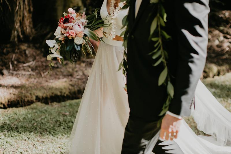 KWH real bride Jana gets a forehead kiss from her new husband Garret. She wears the modern Erin and Lea two piece wedding dress.