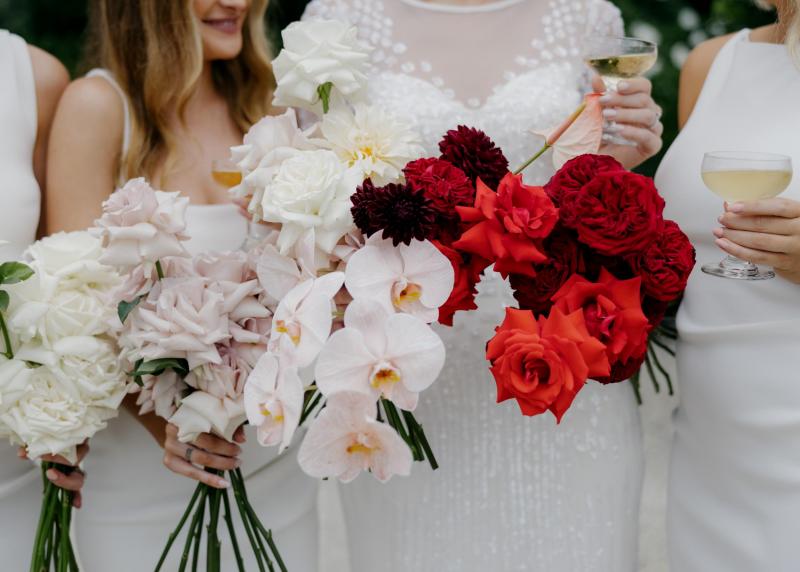 KWH real bride Taylor and Kalen under a clear umbrella. She wears the classic beaded Lexie wedding dress.