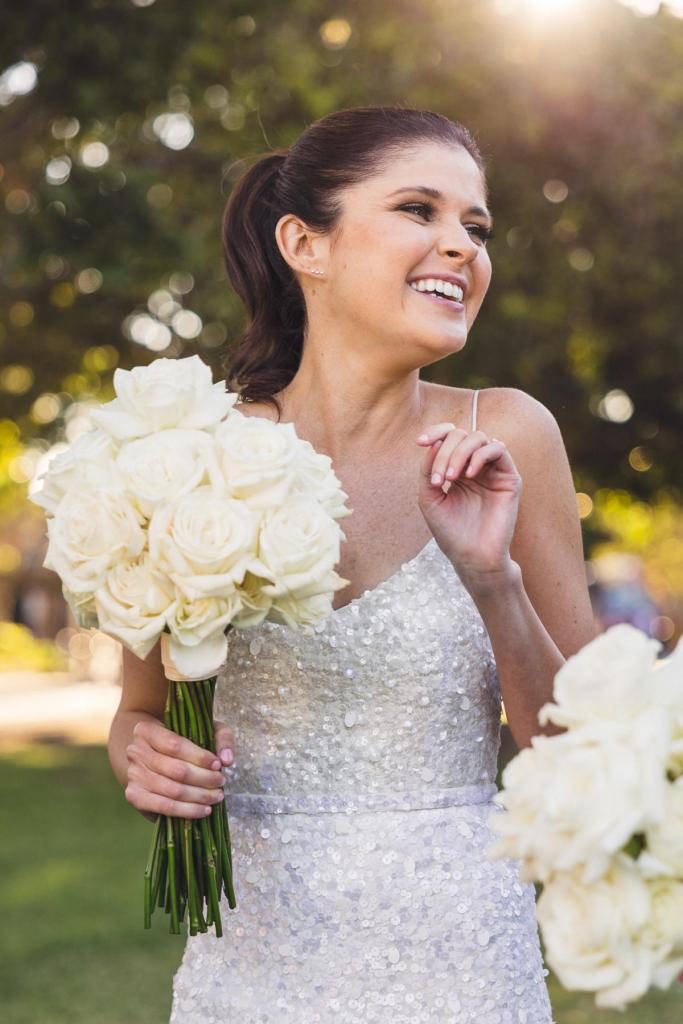 Upclose image of KWH real bride Ash smiling in her Anya wedding dress with thousands of sequins and v-neckline.